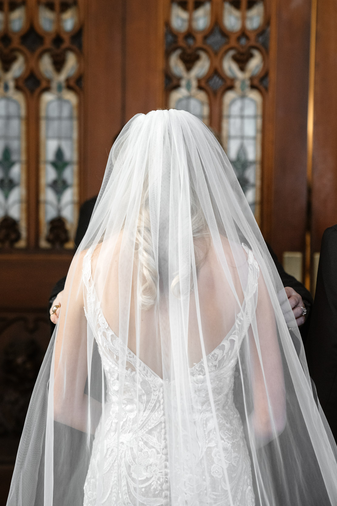 bride adjusting veil before wedding ceremony at St. Patricks cathedral in New Orleans