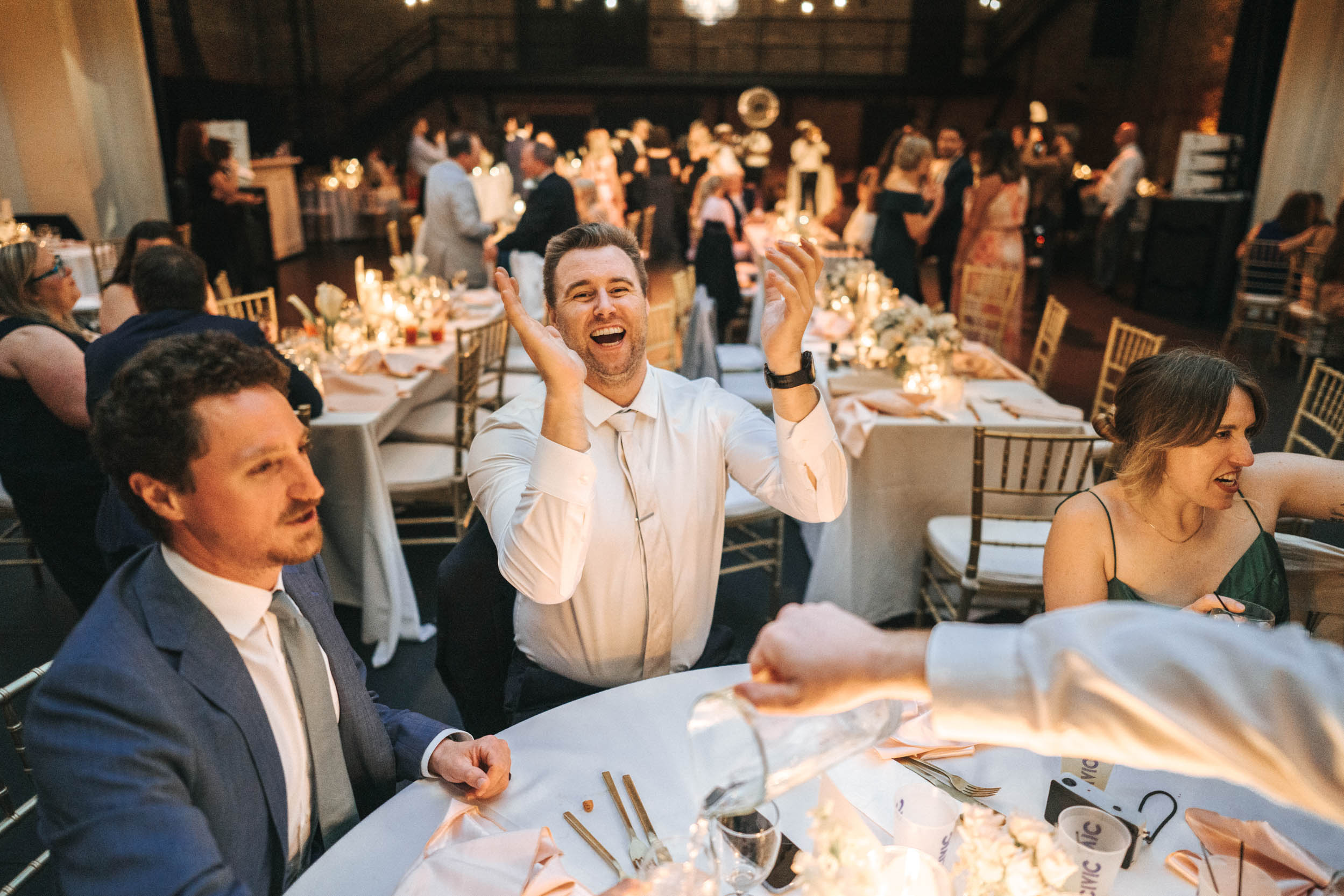 wedding guest laughing during reception at Civic Theater in New Orleans