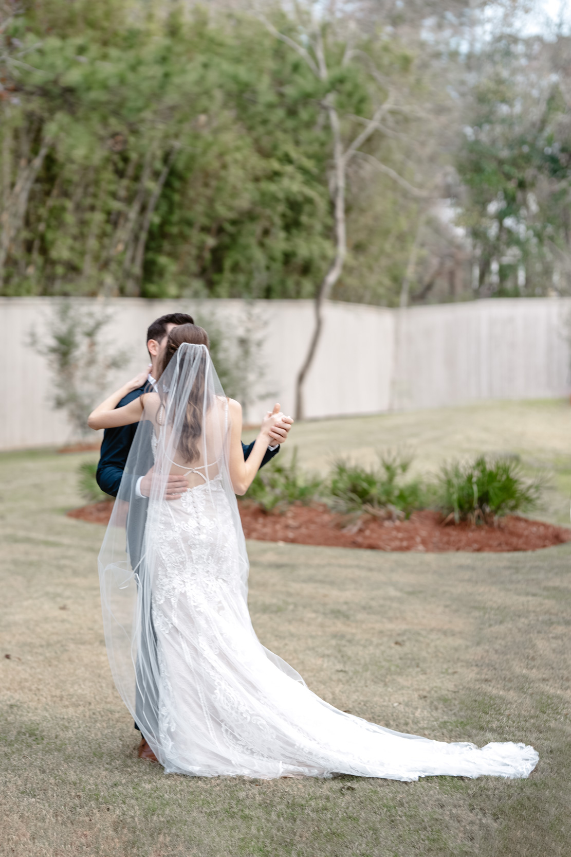 bride and groom slow dancing in a field in Covington, Louisiana
