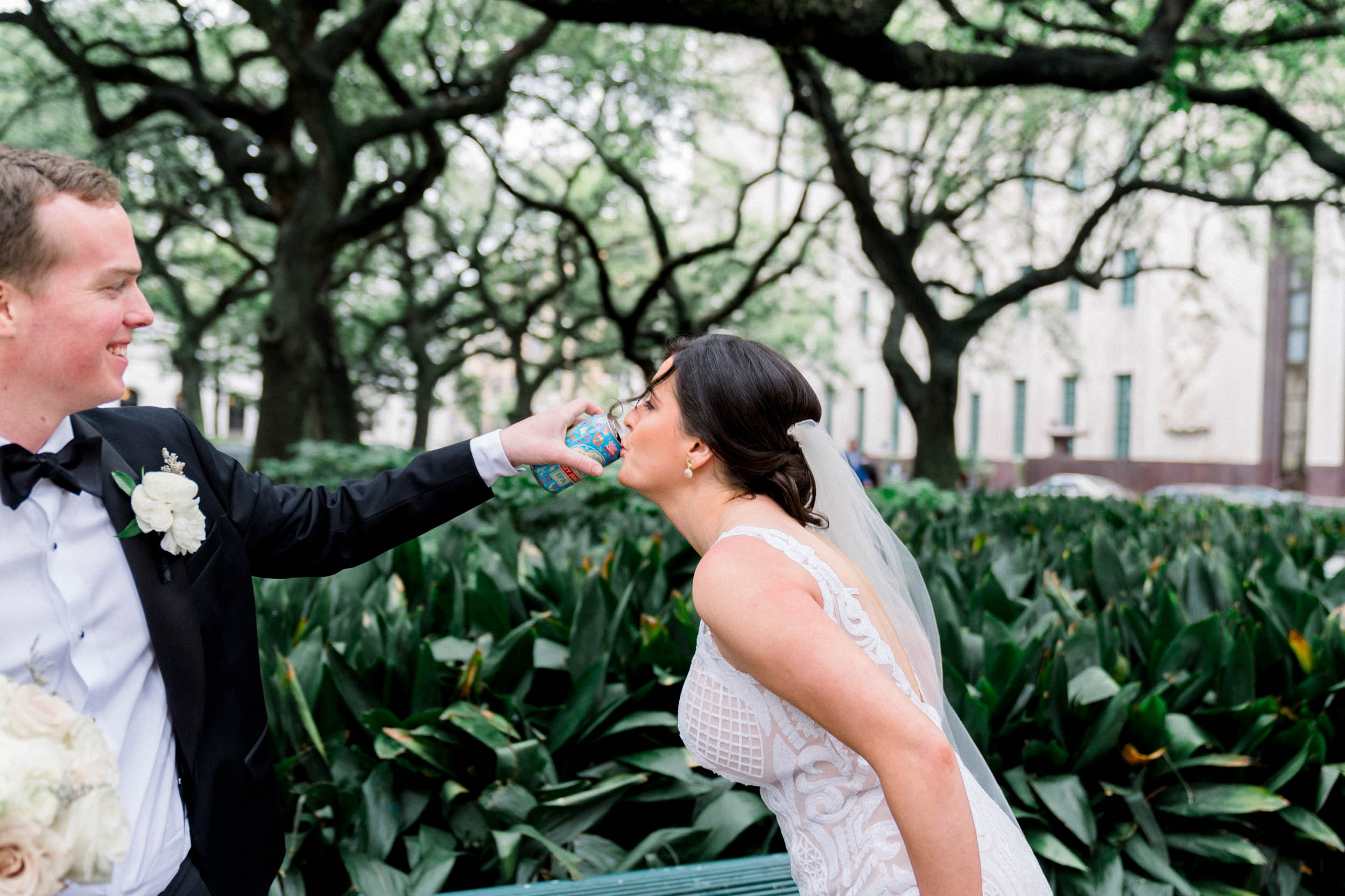 Groom pouring beer in bride's mouth at Lafayette Square in New Orleans.jpg