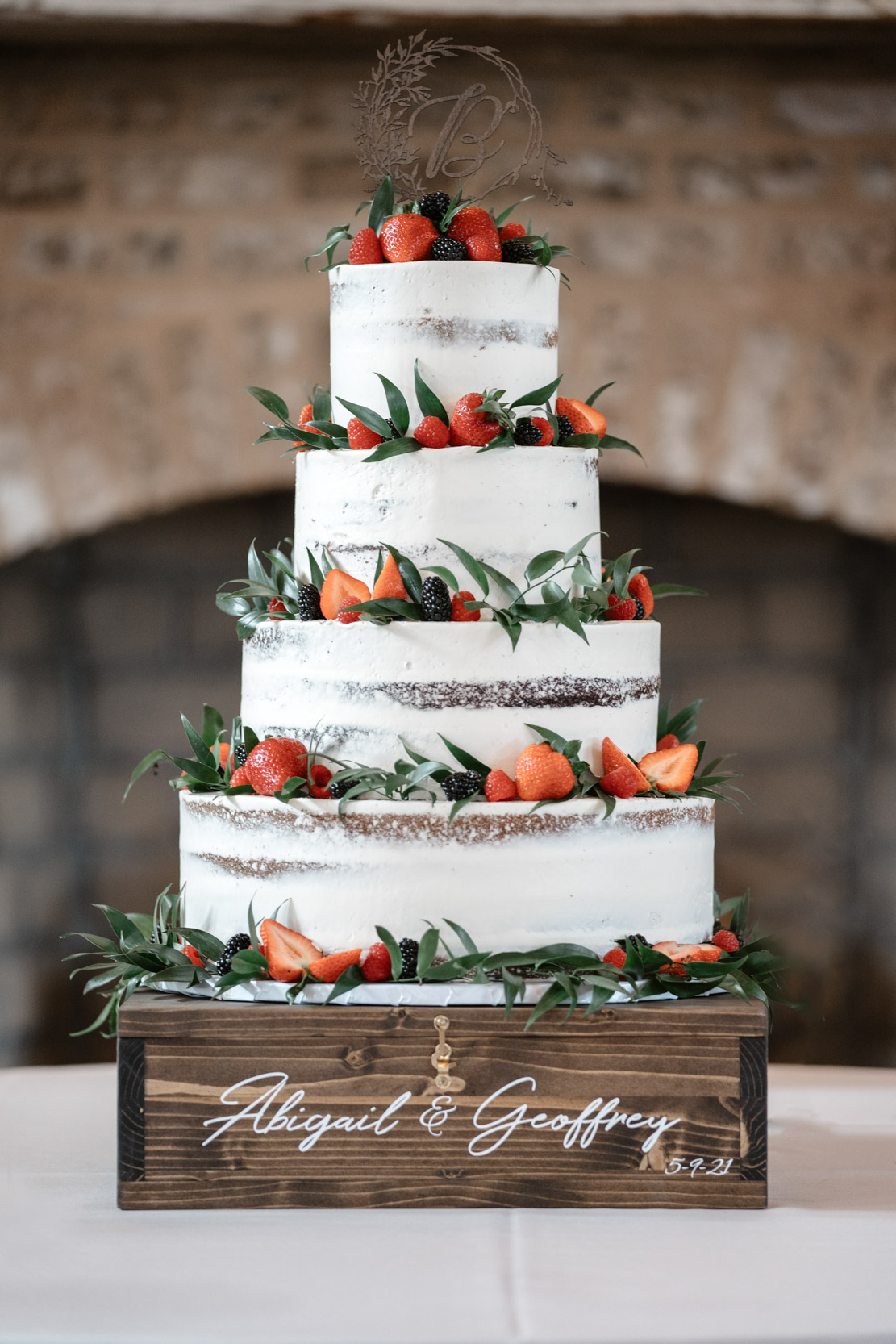 wedding cake with strawberries on table at White Magnolia